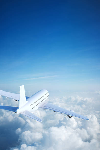 istock White passenger aircraft flying over clouds 1204891811