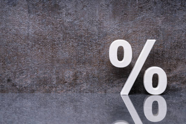 istock Percentage Sign Leaning On Dark Wall 1204893827