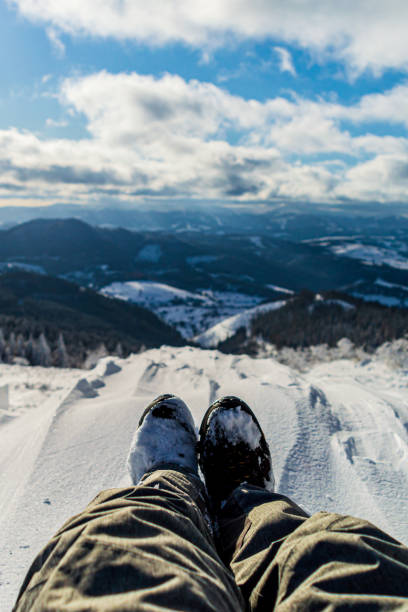 istock Traveler sitting on mountain peak 1204893848