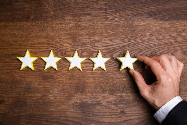 istock Person Placing Five Star Rating Icon 1204894344
