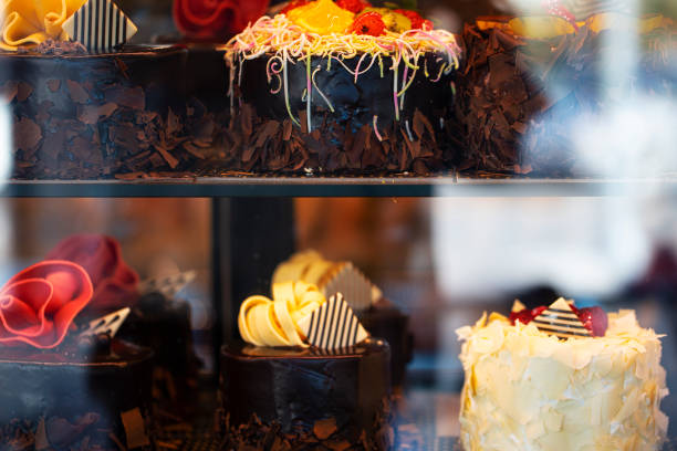 istock Different types of cakes in pastry shop glass display 1204895975