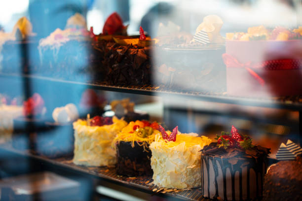 istock Different types of cakes in pastry shop glass display 1204895978