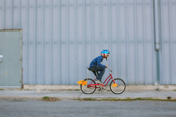 istock Young Boy Racing Bike with Flames 1204896334