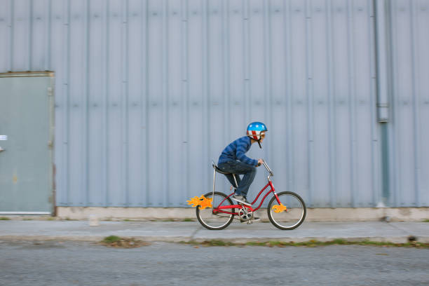 young boy racing bike with flames - ten speed bicycle imagens e fotografias de stock