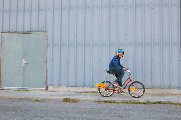istock Young Boy Racing Bike with Flames 1204896406