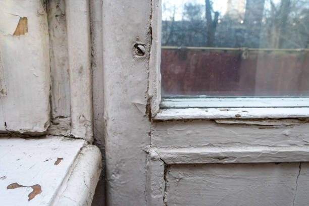 istock Old wooden window with peeling paint and durt needed to be repaired or replaced 1204897214