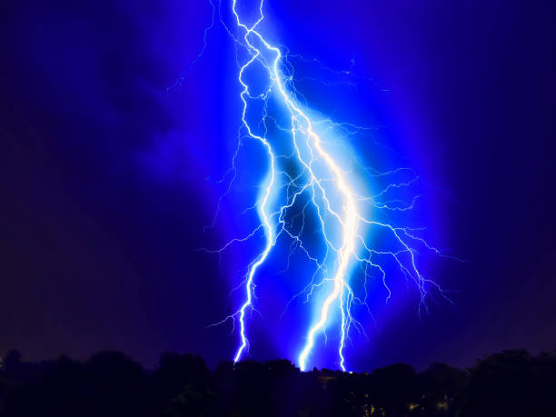 istock Fascinating mysterious beautiful lightning strike on the dark cloudy sky during a spring storm 1204899750