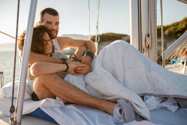 istock Young couple on sailboat at morning 1204900522