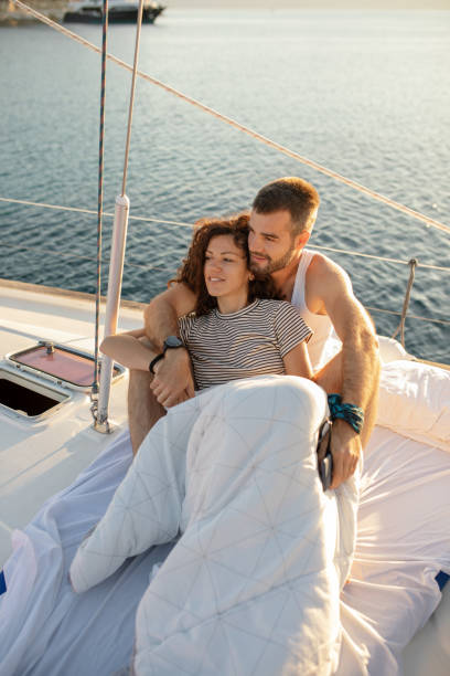 istock Young couple on sailboat at morning 1204903810