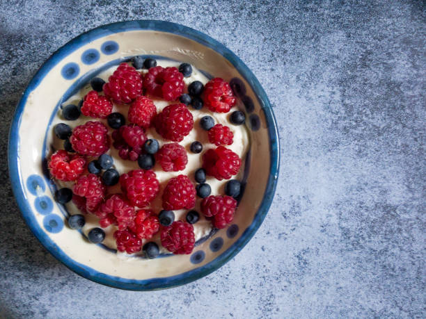 istock Cottage cheese, yogurt, sour cream with blueberries, raspberry 1204903944