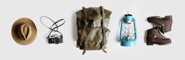 istock Minimalist style composition of hat, backpack and boots on white background isolated 1204906997