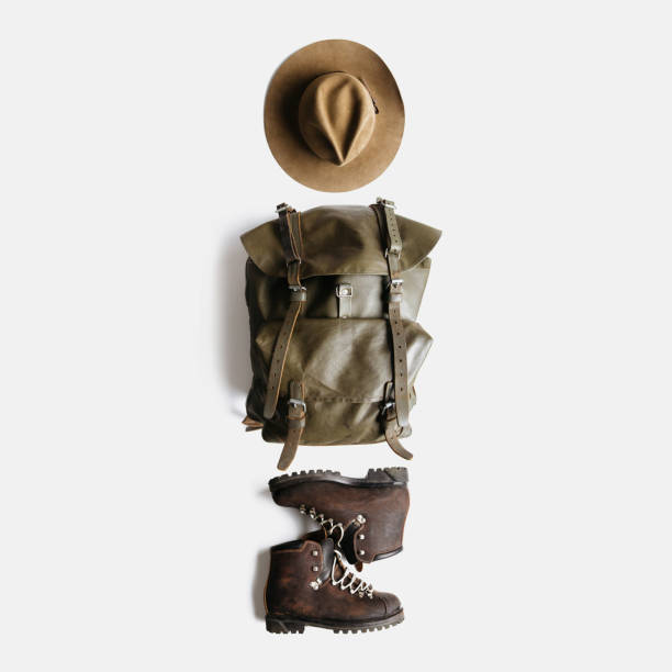 istock Minimalist style composition of hat, backpack and boots on white background isolated 1204907002