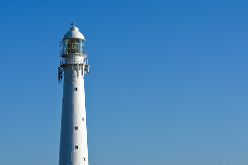 Slangkop lighthouse tower isolated on a clear blue sky, Cape Town, South Africa