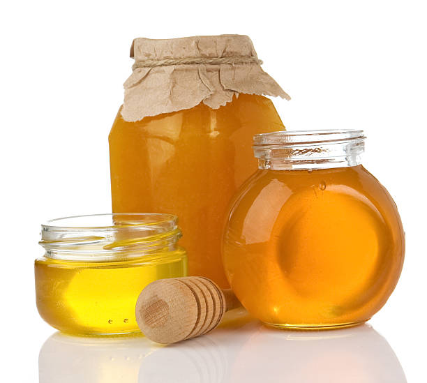 istock glass pot full of honey and stick 120491441