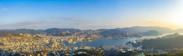 Photo of Nagasaki cityscape panorama view from Mt Inasa observation platform deck in sunny day sunset time