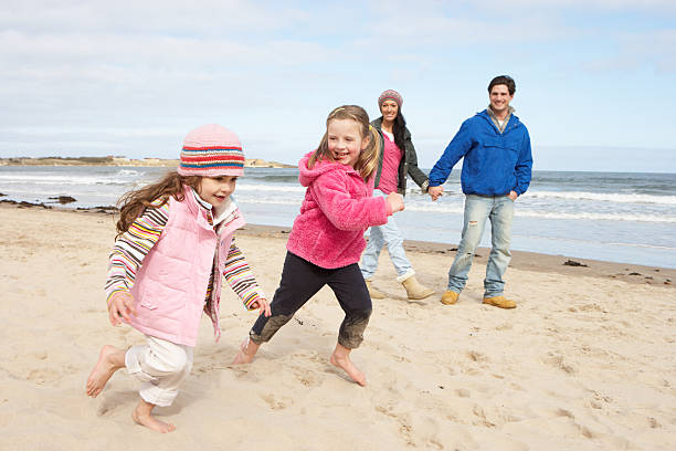 istock Family Walking Along Winter Beach 120492009