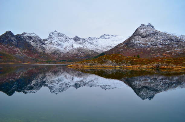 istock Snowy mountains are perfectly reflected in the mountain lake 1204920162