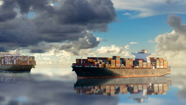 istock Mighty container ships in ocean at sunrise underway performing import and export marine cargo transportation. 1204921065