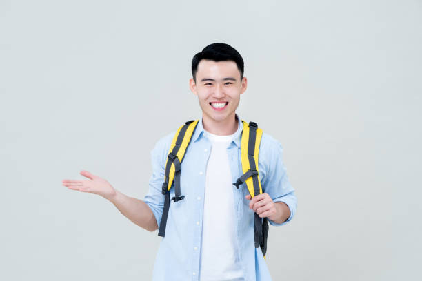 istock Smiling male tourist  doing a open palm gesture 1204923648