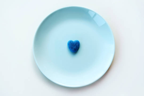 istock Blue lonely marmalade sugar heart on a light pastel blue turquoise mint plate 1204924818
