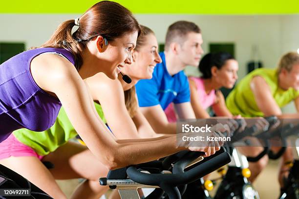 Indoor Bycicle Cycling In Gym Stock Photo - Download Image Now - Exercise Bike, Activity, Adult