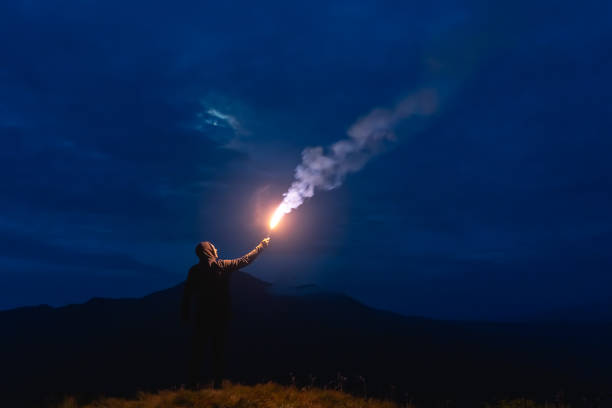 istock The male with a firework stick standing on a mountain 1204927755