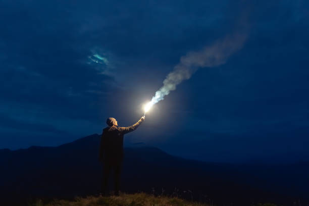 istock The male with a firework stick standing on a mountain. night time 1204927759