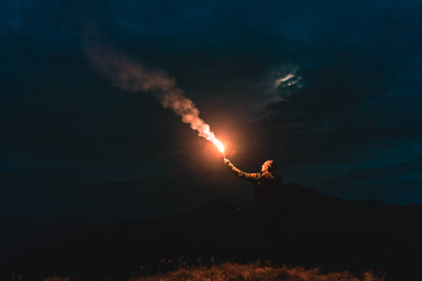 istock The male standing with a firework stick on the night mountain 1204927800