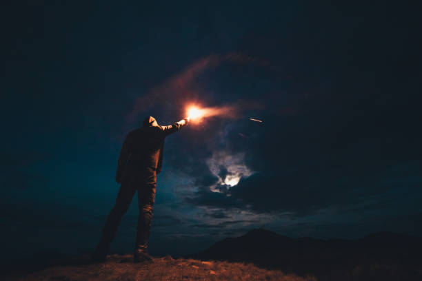istock The male with a firework stick standing on the night mountains 1204927802