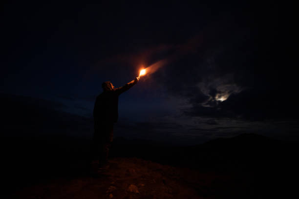 istock The male with a firework stick standing on the night mountain 1204927803