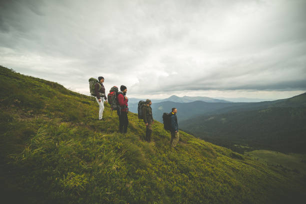 istock The four hikers with backpacks standing on a mountain 1204927812