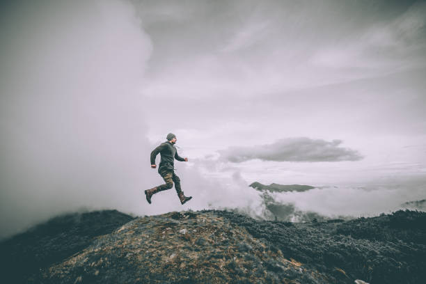 istock The man jumping on the mountain on a beautiful clouds background 1204927813