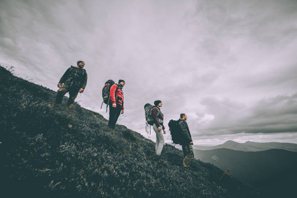 istock The four people with backpacks standing on the mountain 1204927837