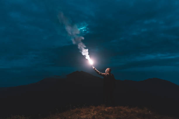 istock The man standing with firework stick on the mountain 1204927845