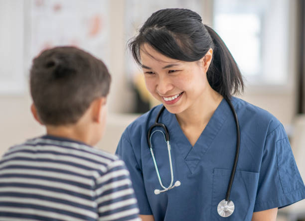 istock Doctor Talking with A Young Boy stock photo 1204929151