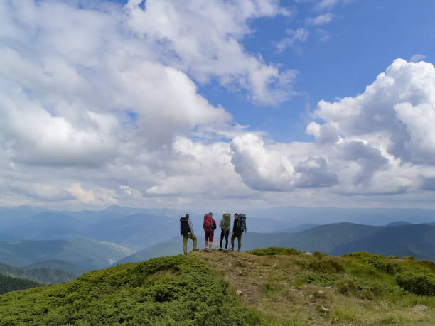 istock The four active people standing on the picturesque mountain 1204930401