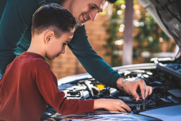 istock The father and son looking under the car hood 1204931081