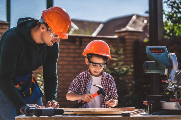 istock The father shows his little son how to use hammer 1204931109