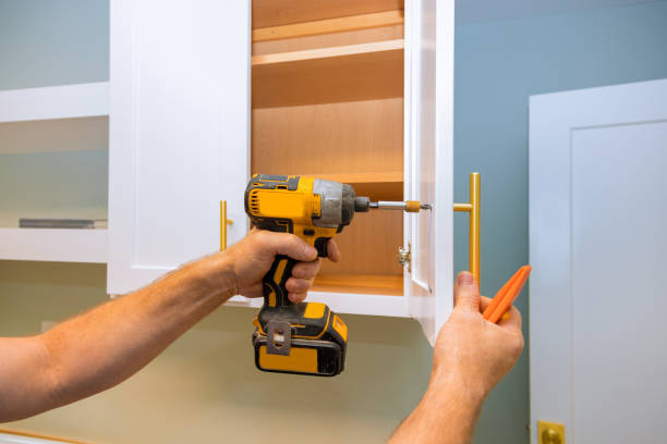 istock Home improvement contractor installing new kitchen cabinet door hinge 1204933211