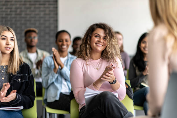istock University Students Sitting in a Lecture Clapping stock photo 1204939197