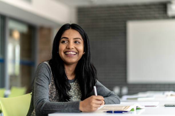 istock Attractive University Student Working on Homework stock photo 1204939214