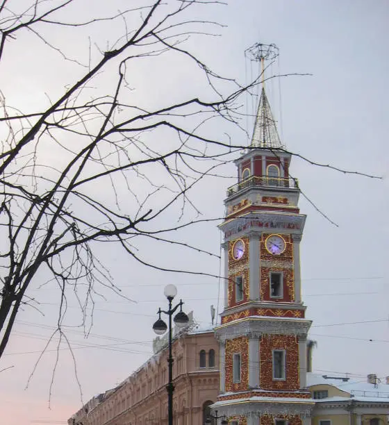 The building of the City Council. Nevsky Prospect. Fairytale tower with a luminous clock. Bright garland. New Year mood. Evening. Illumination of a big city. The architectural style is classicism. Campanile Tower.