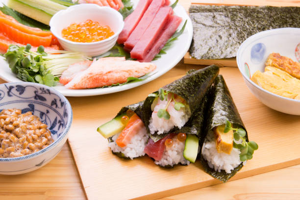 sushi arrotolato a mano - temaki food sushi salmon foto e immagini stock