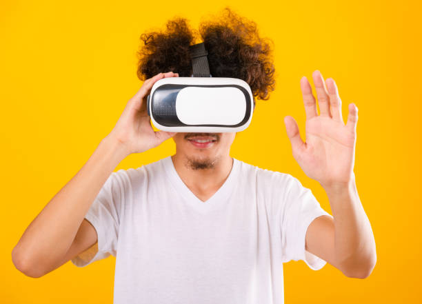 istock Asian handsome man with curly hair he using virtual reality headset or VR glass 1204947324