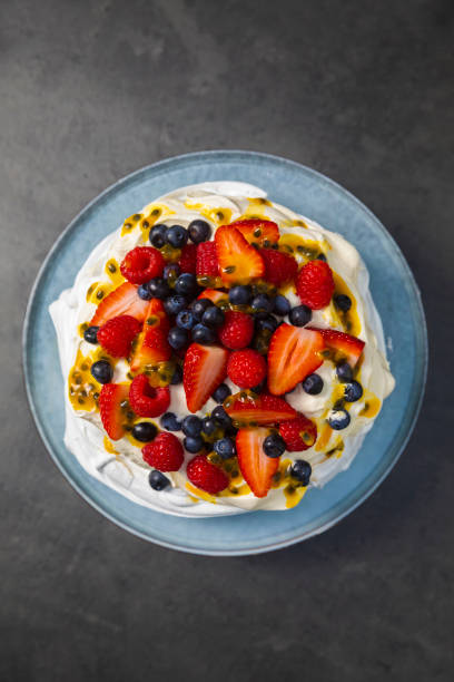 istock Pavlova dessert top down above with dark slate background 1204955125