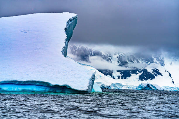 istock Floating Blue Green Iceberg Closeup Water Antarctica 1204959199