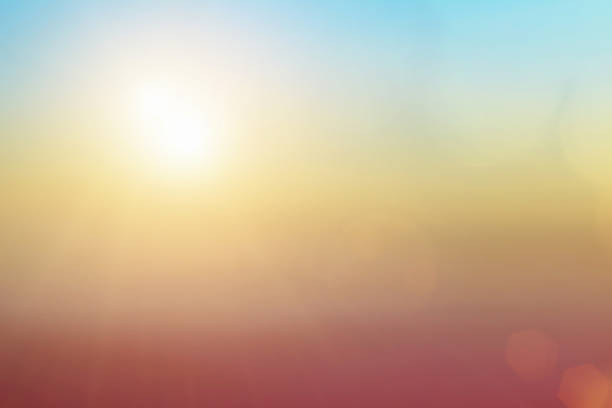 istock Natural background blurring warm colors and bright sun light. Bokeh or Christmas background Green Energy at sky sunny color orange light patterns plain abstract flare evening clouds blur. 1204977928