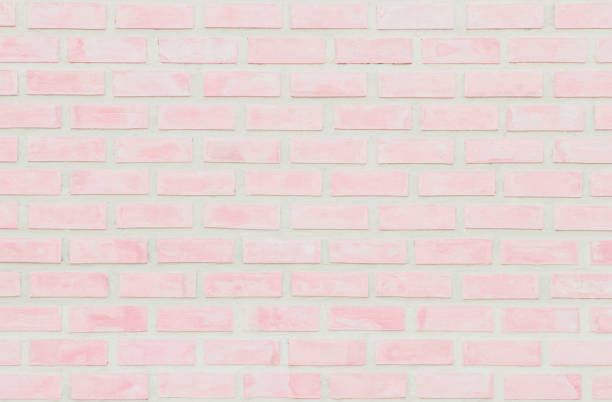 istock Pastel Pink and White brick wall texture background. Brickwork or stonework flooring interior rock old pattern clean concrete grid uneven brick design stack. Home or office design backdrop decoration. 1204978449