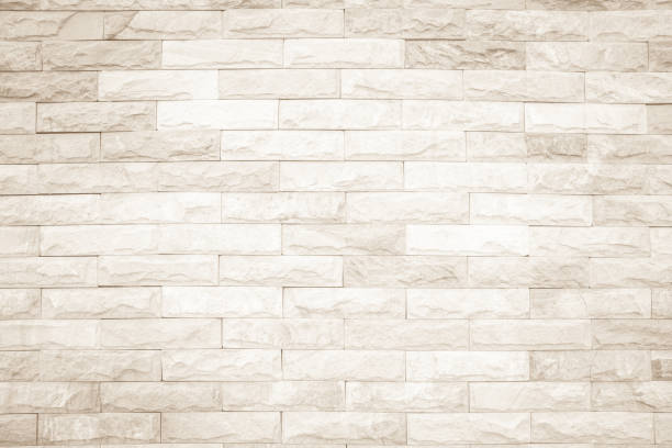 istock Cream and white wall texture background, brick stone pattern modern decor home and vintage stonework floor interior or design concrete old brickwork stack limestone seamless nature for copy space. 1204978612