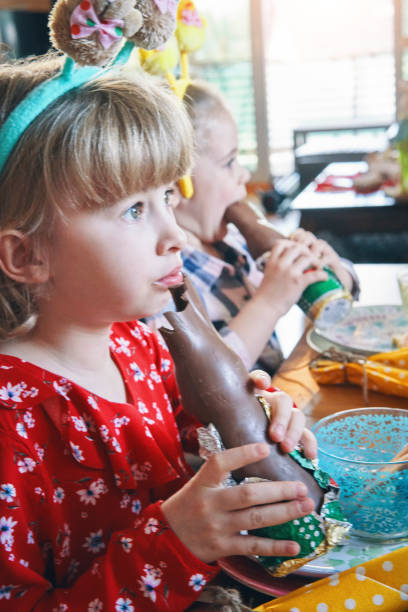 istock Little Girl Eating Chocolate Easter Bunny 1204980804